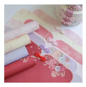 Close-up of Chinese style floral wrapping paper with elegant qipao frog button details