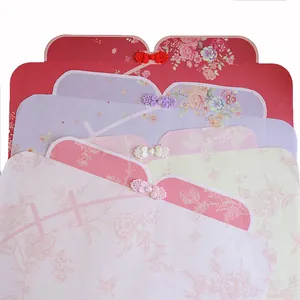 Traditional Chinese Qipao style floral wrapping paper with elegant frog fasteners