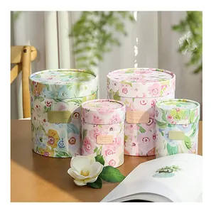 Group of floral cylindrical flower boxes arranged on a desk with natural lighting
