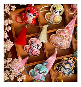 Close-up of traditional Chinese Year of the Snake embroidered sachets with colorful tassels