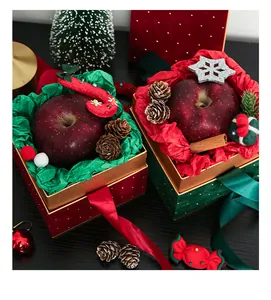 Primo piano di scatole regalo di Natale in velluto con pois stellati e decorazioni festive