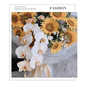 Close-up of frosted translucent wrapping paper used for a sunflower and orchid bouquet.