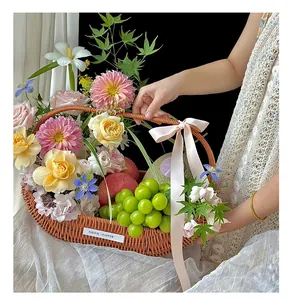 Handwoven imitation rattan fruit and flower basket decorated with fresh roses and grapes