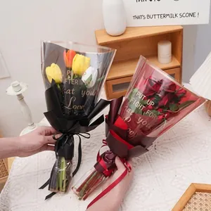 Detail showing two tulip bouquets wrapped in embossed black and red textured paper