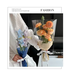 Detail view of transparent flower bouquet bags with gold Hand Bouquet lettering.