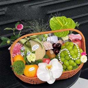 Creative woven brown gift basket filled with fresh fruits and floral decorations