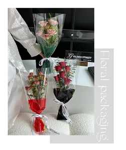 Detail of transparent floral packaging bags with gold lettering and colored bases