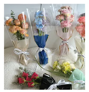 Detailed view of transparent flower bouquet bags with gold HAND BOUQUETS lettering.