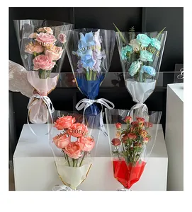 Close-up of transparent flower bouquet packaging bags with gold HAND BOUQUETS text