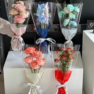 Transparent flower packaging bags with gold Hand Bouquets lettering and white ribbons