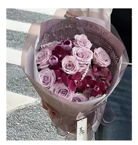 Elegant purple rose bouquet wrapped in honeycomb and waterproof floral paper