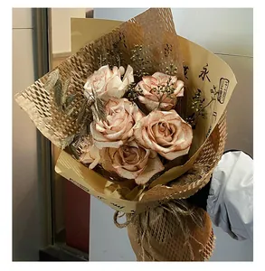 Detailed view of vintage rose bouquet wrapped in honeycomb paper floral packaging