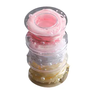 Stacked rolls of elegant pearl-embellished ribbons for gift wrapping and flower decor