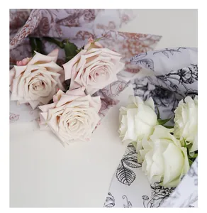 Detail view of vintage floral patterned wrapping paper for elegant rose bouquets.