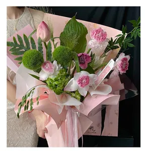 Aesthetic pink lotus bouquet wrapped in oriental dream themed florist packing paper.