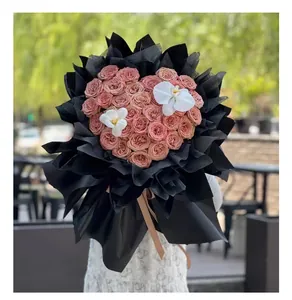 Heart-shaped rose bouquet with black wrapping paper for Valentine's Day flower arrangement