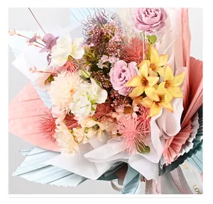 Close-up of layered colorful milk cotton and pleated flower wrapping paper with ribbon