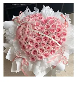 Heart-shaped pink rose bouquet with white wrapping and ribbon for Valentine's Day