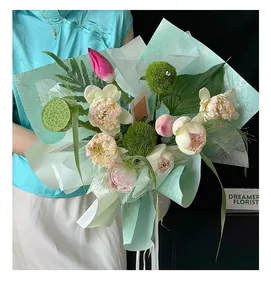Close-up of elegant oriental style floral bouquet wrapped in cyan patterned paper