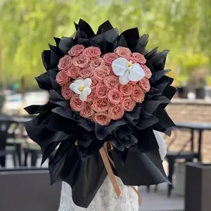 Romantic heart-shaped rose bouquet arrangement for Valentine's Day in black pleated wrap