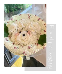 Detailed view of DIY carnation puppy bouquet with elegant rose flower wrapping paper