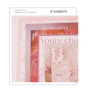 Close-up of romantic pink floral wrapping paper sheets with elegant typography.
