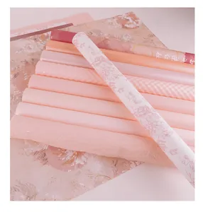 Close-up detail showing various textures of romantic pink and peach bouquet wrapping paper