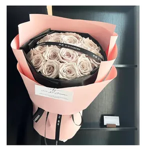 Elegant lilac rose bouquet wrapped in pink and black paper with premium brand ribbon