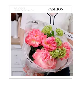 Detailed view of waterproof transparent OPP wrapping paper with romantic text on a peony bouquet