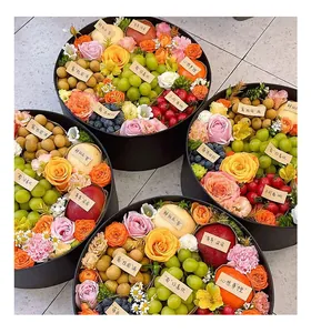 Luxury circular gift boxes filled with fresh fruits and roses for floral packaging.