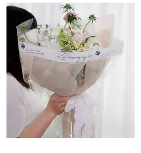 Close-up of floral gift wrapped in waterproof OPP cellophane with English print