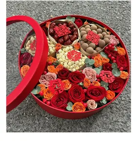 Detailed view of large red circular floral gift box featuring roses and assorted dried fruits