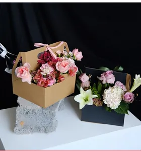 Elegant handheld floral packaging boxes with ribbon bows for flower arrangements
