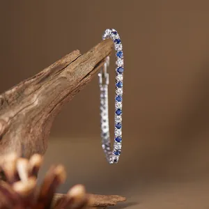 Detailed macro view of S925 silver tennis bracelet with blue and white gemstones