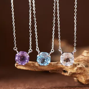 Macro view of octagonal cut natural amethyst, topaz, and white crystal necklaces