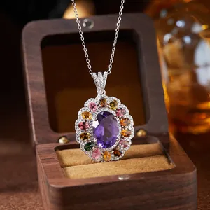 Detail view of a S925 silver necklace featuring an amethyst and colorful gemstones