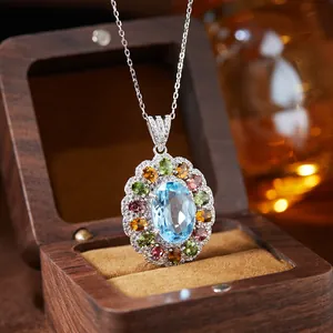 Macro view of a luxury S925 silver pendant with a blue topaz and colorful gems