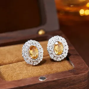 Close-up of yellow oval gemstone stud earrings with halo setting in S925 silver