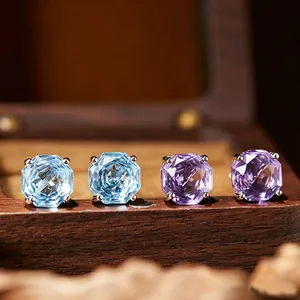 Detailed view of octagon-cut blue topaz and purple amethyst silver stud earrings
