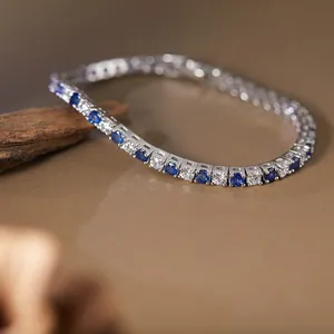 Elegant S925 silver tennis bracelet featuring blue and white round gemstones detail.