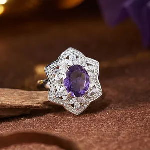 Close-up detail of silver amethyst ring featuring a stunning floral gemstone halo design
