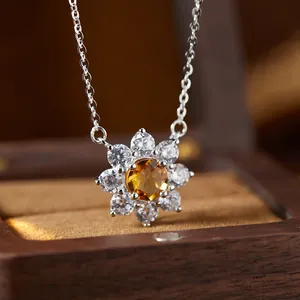 Detailed close-up of a floral S925 sterling silver necklace with a yellow citrine pendant