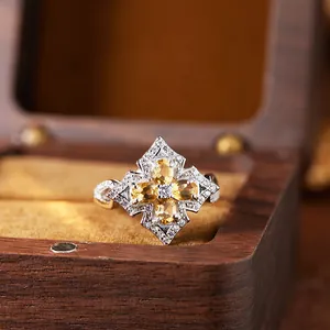 Detail close-up of a vintage s925 silver ring featuring four oval yellow citrine stones