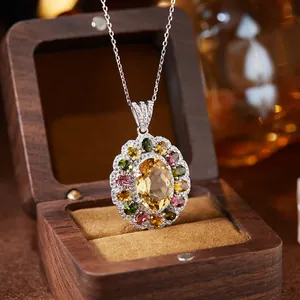 Macro view of S925 silver necklace with oval citrine and colorful gemstone halo design.