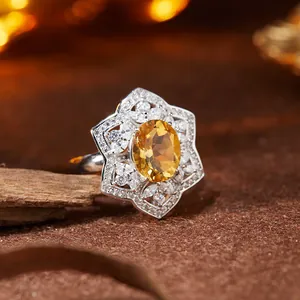 Close-up macro of an S925 silver ring with a natural citrine in a floral setting