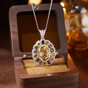 Detailed view of S925 silver pendant with oval citrine and colored gemstones in wood box