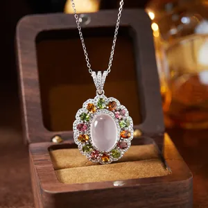 Macro view of a colorful gemstone pendant featuring rose quartz and multi-colored stones