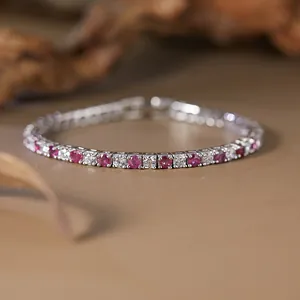 Macro view of sterling silver tennis bracelet with red rubies and cubic zirconia