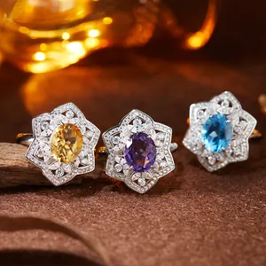 Macro view of S925 silver rings set with natural citrine, amethyst, and topaz gemstones.