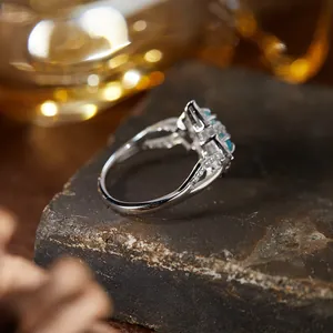 Macro view of a s925 silver ring featuring vibrant blue gemstones and pave-set accents